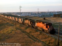 There's no shortage of power on this extra freight rolling into Saskatoon, seen passing through the suburbs of Sutherland at the Highway 5/College Dr. overpass before arriving at CP's Sutherland Yard. CP SD40-2 5625 and 5582 lead GP9 units 8484 (still in maroon & grey script paint), 8701, 8683 and 8685, and a fresh-looking SW900 6711 trailing with stack capped.
<br><br>
Motive power sheets show 6711's regular assignment at the time was Edmonton, so it could have been coming back from Winnipeg's Weston Shops after receiving some maintenance work (it wasn't equipped with MU so wasn't online). All the GP9's shown were Winnipeg-based numbers, so they're possibly being forwarded for branchline assignments in the region.
<br><br>
<i>Eric W. Johnson photo, Dan Dell'Unto collection slide.</i>