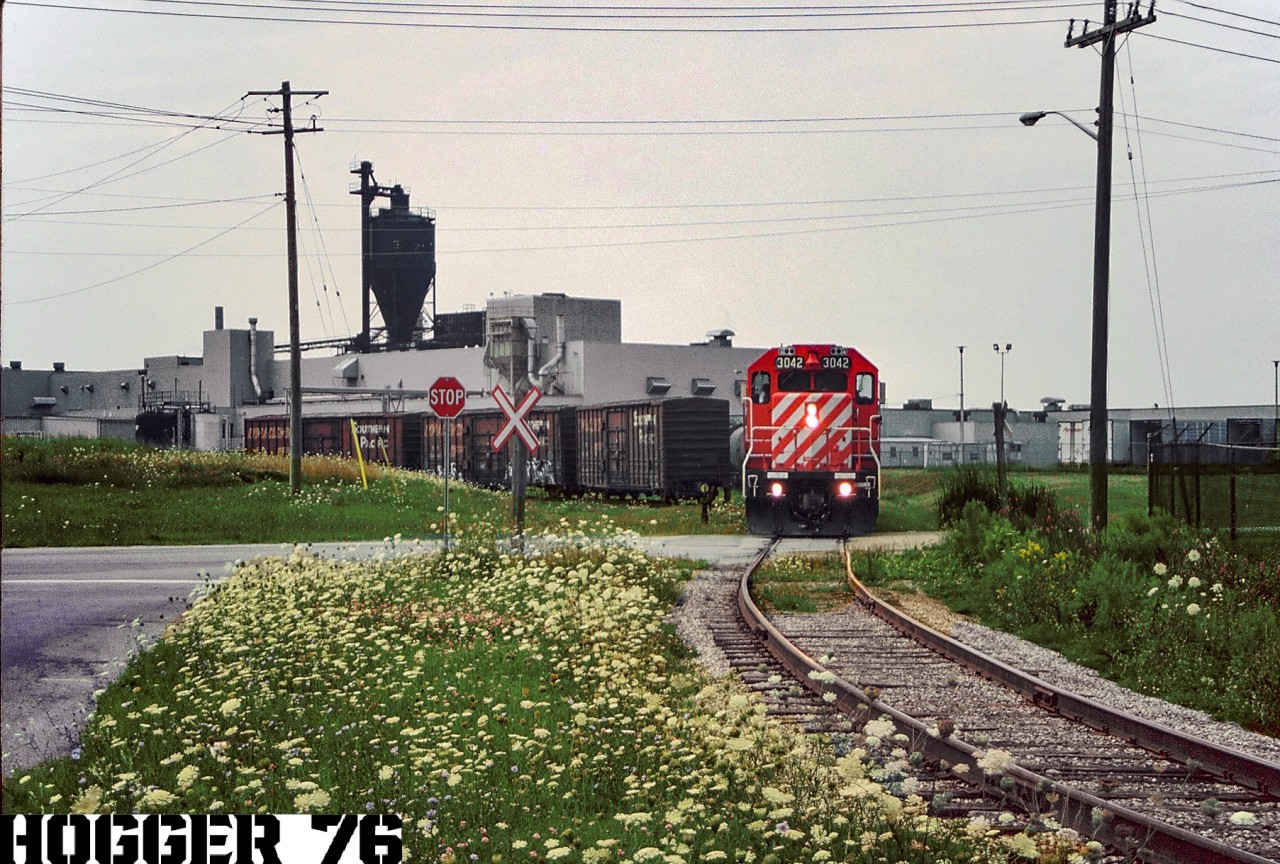 The CP/STLH “Grand River Job” based out of Galt Yard in Cambridge, Ontario is busy switching the very large Uniroyal Goodrich Plant in Kitchener, Ontario on the Goodrich Spur. The power was GP38-2’s 3042 and 3047.