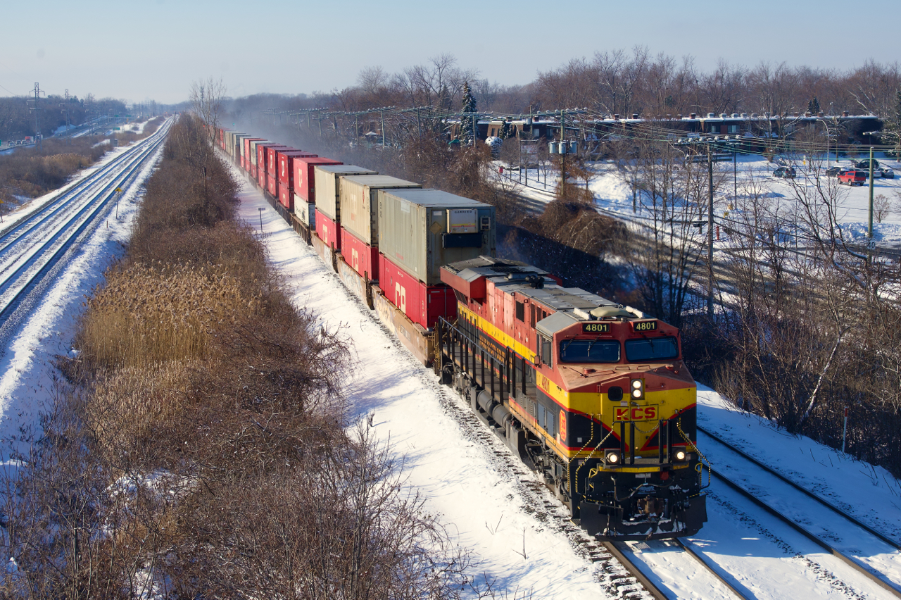 A KCS ES44AC leads stacks eastbound.