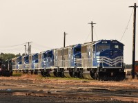 While up in the northern Manitoba town of The Pas, looking for Keewatin's new power, we of course checked out the yard in town. And there sat a long string of 'new' HBRY SD60M locos, seemingly being stored. (The CTG lists a dozen of them- 6000-6011) They apparently were being overlooked in favour of HLCX 'geeps' which while we were there powered the morning train north to Thompson.
It certainly would have been nice to see these attractively painted units in action.