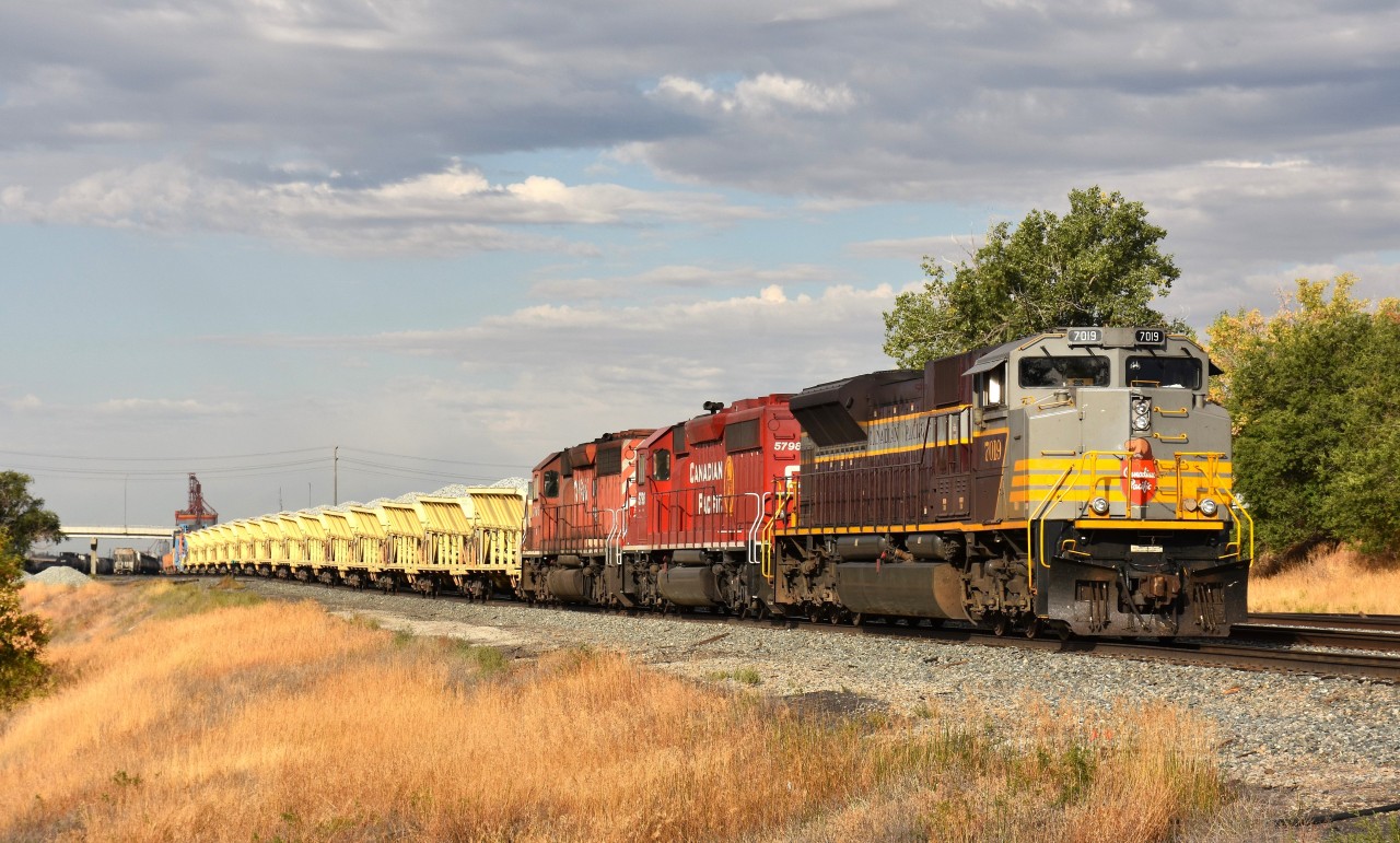 On the move eastward out of Swift Current CPKC yard is CP 7019, 5798 and 5766 with a GREX ballast dumping train. GREX 9500 is the blue spreader and behind is a long 'slot machine' string of ballast cars with excavator on rail cart.
GREX is the reporting mark of Georgetown (Texas) Rail Equipment Company. It was taken over and merged with Loram in 2018-2020 and I am wondering if the GREX identity is going to be phased out.