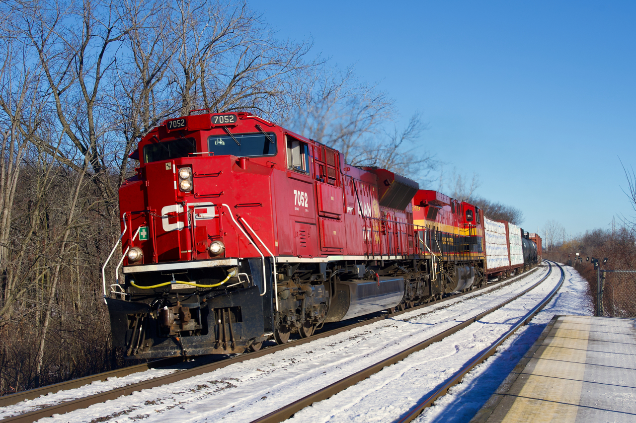 CP 7052 pops as it leads CPKC 231 through Île-Perrot, with KCS 4619 trailing.