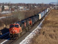 CN X309 has an ES44AC and an SD70I for power as it heads west with extra tonnage out of Joffre Yard.