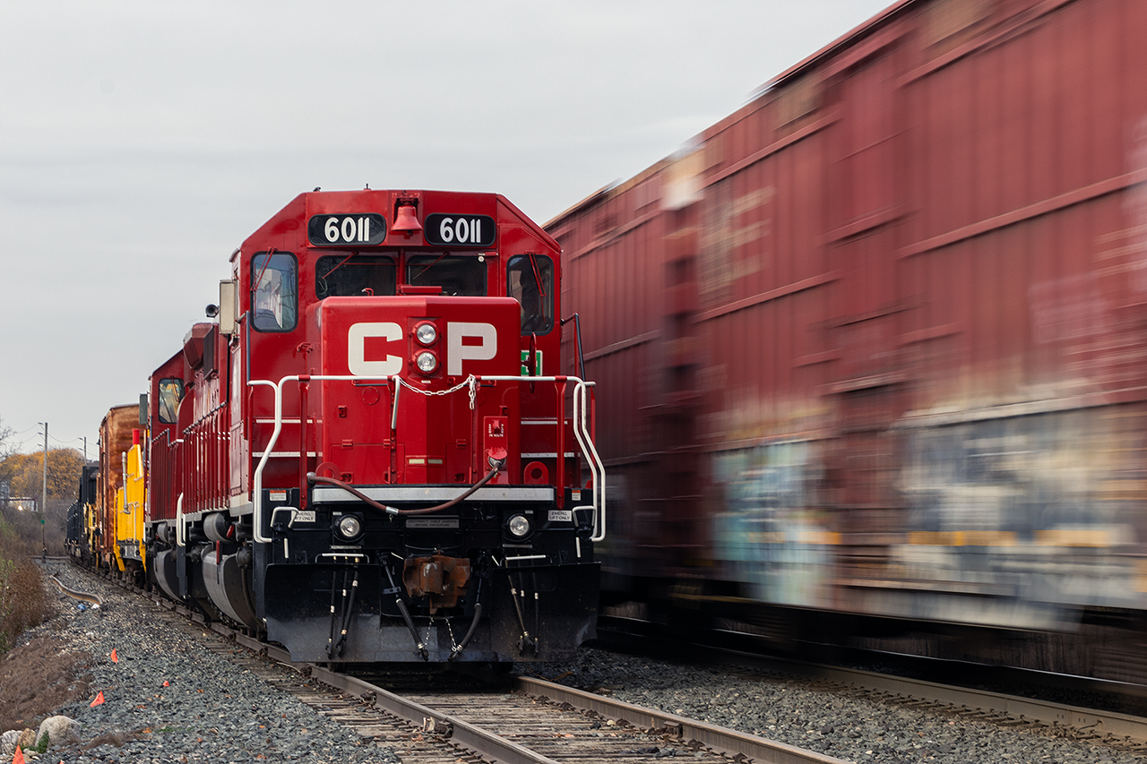 The rail train awaits its crew as 134 flies by on a chilly morning.