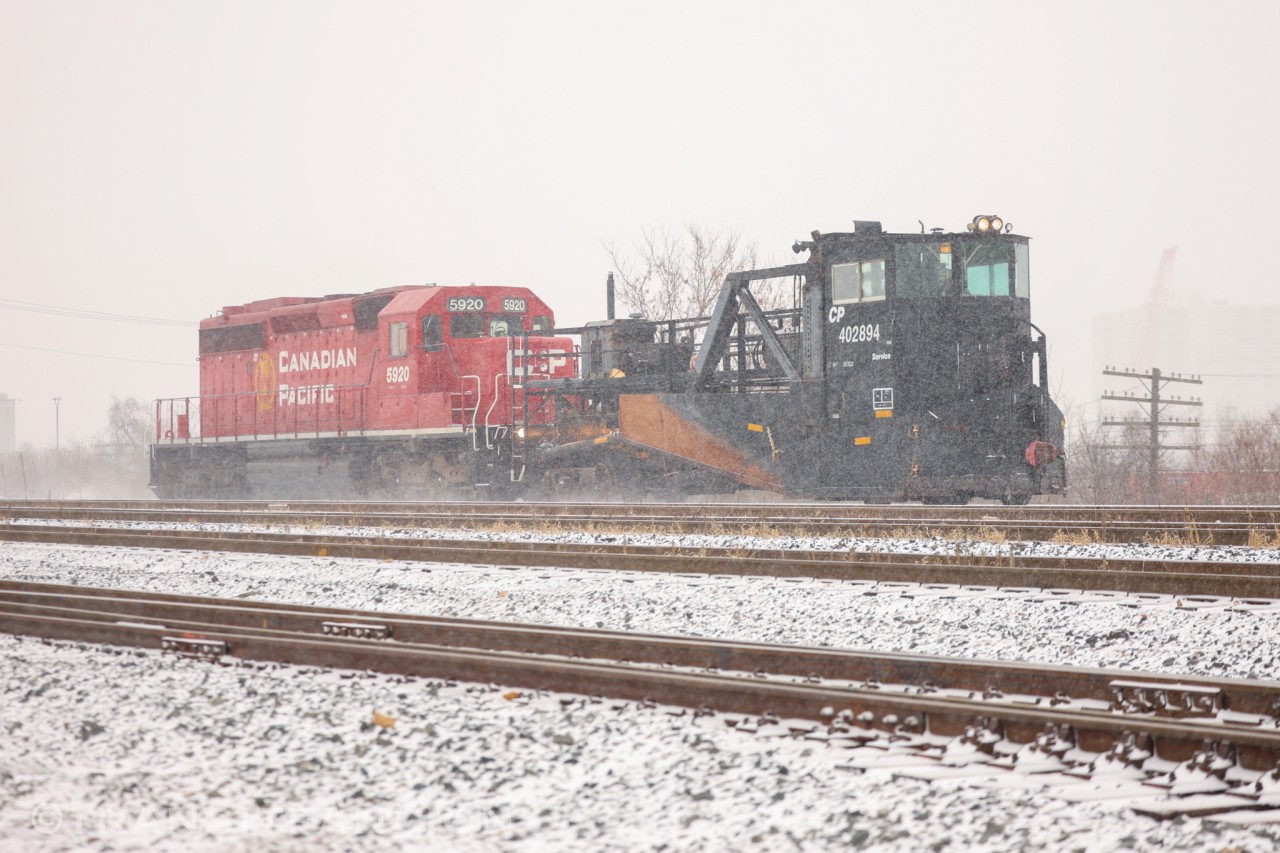 CP PLOW-04 with CP 5920 for power, jordan spreader CP 402894 being pushed, heading up to Midhurt to pick up a foremen then start plowing the sidings on northern portion of Mactier sub.