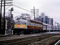 Rolling across Westminster Avenue, CPR E8A 1800 departs Montreal West station with train 233, <i>The Rideau,</i> bound for Ottawa.<br><br><i>Scan and editing by Jacob Patterson.</i>