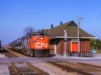 The engineer aboard train 628 from Stratford to Toronto gives a wave as the train flies past Malton station, crossing Scarboro Street, today the only grade crossing remaining on the Weston Sub.  With GO Transit assuming commuter operations in 1974, a new station was built further east, with this 1912 structure being demolished around the same time.

<br><br><i>Scan and editing by Jacob Patterson.</i>