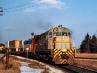 CPR 903 from Montreal takes the switch from the Belleville Sub onto the Staines Lead with an MLW C424 and GMD 4000-series FP7A on the headend.

<br><br><i>John Freyseng Photo, Jacob Patterson Collection Slide.</i>