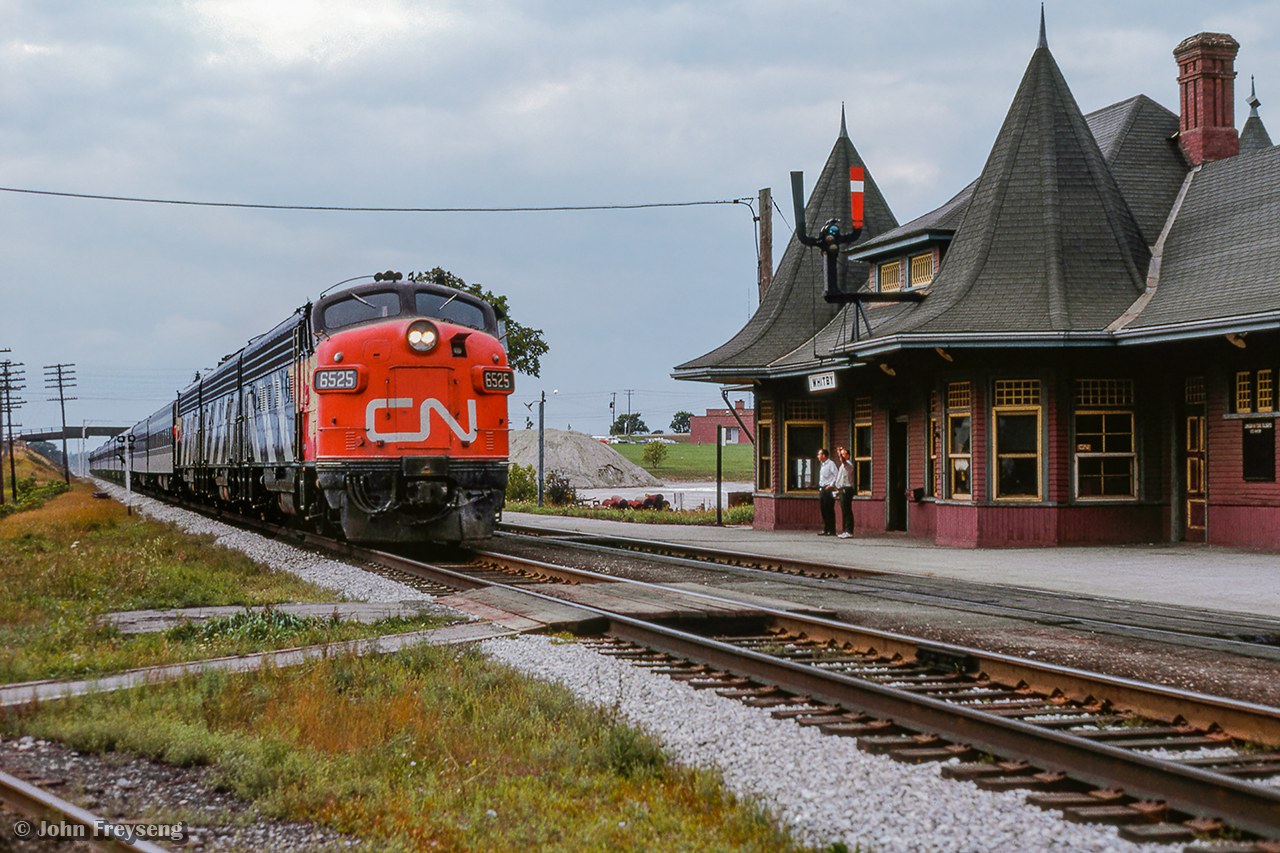 CN Rapido 64 passes through Whitby ducking under Henry Street near the 1912-built station.  Passenger service to this station ended in 1969, with it being relocated in 1970 by a group of local artists to the corner of Henry and Victoria Streets, just south of its original location.  In 2004 it would be moved again, just across the street where it remains today.

Scan and editing by Jacob Patterson.