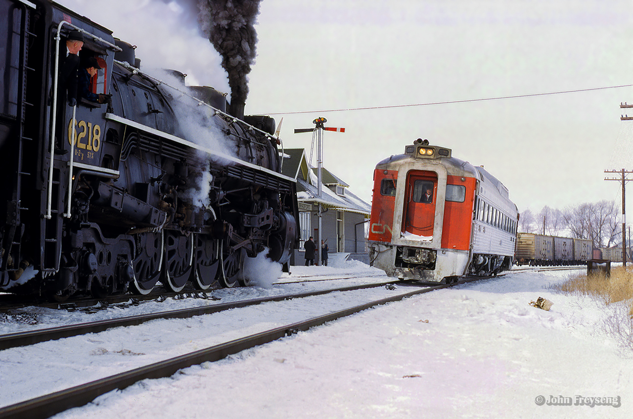 The Upper Canada Railway Society's Barrie Winter Carnival Special pauses at Bradford to meet trains 674 (North Bay - Toronto), and 673 (Toronto - North Bay).  D112 is the RDC assigned to 674 today, pausing for orders alongside 6218.

Scan and editing by Jacob Patterson.