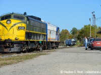 This was 10 years ago when I was younger and my photography shows it, but here's some of the human  side of railroading. I bet many folks will browse by this image and go "oh another shot of some OSR F units, there's so many shots of these" but this isn't any ordinary subject matter and the feller in blue isn't just some 'fan. Those who know know right away who that is at right: OSR Founder and President Kenneth (Jeff) Willsie taking a giant puff of a cigarette while watching his F units park for Lunch at the CP Woodstock Station. Jeff's red Suzuki Swift is parked at right with Jeff's handprints all over the trunk as he would have to get in there to grab his radio or safety vest, if he chose to wear one. Jeff's wearing the classic Canadian Tuxedo on this fine October day while a Canadian flag flaps in the breeze at the station. The folks at OSR already had paint in mind for 6508 and by the <a href=http://www.railpictures.ca/?attachment_id=20303 target=_blank>next summer it would be in OSR paint</a>. Jeff was always friendly and I saw him so often in this era watching his F units work, sometimes he was even in the Engineer's seat. What's your favorite memory of Mr. Willsie? Please add a comment below.