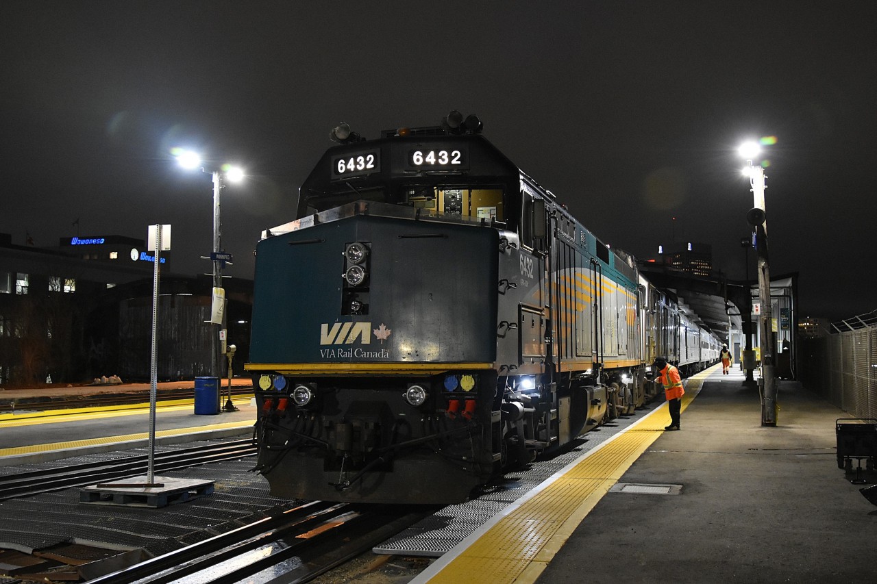 Nice Wheels  
VIA 6432 is on the point of VIA #1 at the Winnipeg train shed Union Station in Winnipeg, MB on a very cold November 21, 2024 evening. 
While the consist gets an undercarriage and truck inspection, I was able to make way to the end of the station platform for a head end shot. :-)