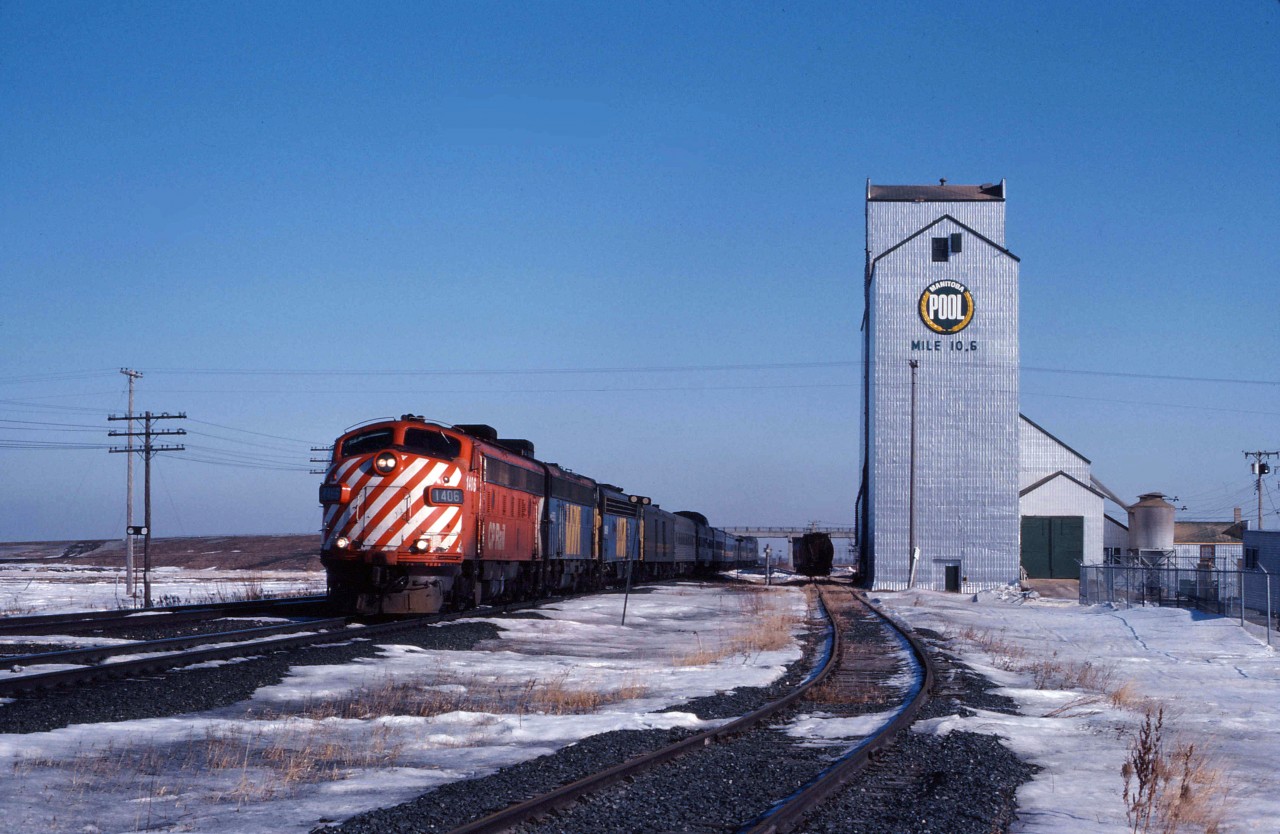 Roughly three months after the devastating November 1981 VIA cuts when the Super Continental was discontinued, "The Canadian" is leaving the City of Winnipeg as it makes its way west. It will switch from CN's Rivers sub to the CP Carberry sub using the connecting track at West Tower (just beyond the Portage la Prairie station) then continue over the traditional CP route through Regina and Calgary before rejoining CN in the Lower Mainland with a final destination of the former CN station in Vancouver. Alas, this routing will end in January 1990 when the Canadian is cut back from a daily train to three days per week and permanently routed over CN lines. Most of VIA's former CP units will be retired by 1983 (with the exception of several which were remanufactured and remained in service until 1990). So, enjoy this scene from over 40 years ago as three former CP units (FP9 1406 in CP Rail paint, an FP9 repainted for VIA, and one of VIA's two E8As also in VIA paint) lead the "pride of the fleet" west across the prairies.