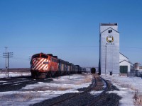 Roughly three months after the devastating November 1981 VIA cuts when the Super Continental was discontinued, "The Canadian" is leaving the City of Winnipeg as it makes its way west. It will switch from CN's Rivers sub to the CP Carberry sub using the connecting track at West Tower (just beyond the Portage la Prairie station) then continue over the traditional CP route through Regina and Calgary before rejoining CN in the Lower Mainland with a final destination of the former CN station in Vancouver. Alas, this routing will end in January 1990 when the Canadian is cut back from a daily train to three days per week and permanently routed over CN lines. Most of VIA's former CP units will be retired by 1983 (with the exception of several which were remanufactured and remained in service until 1990). So, enjoy this scene from over 40 years ago as three former CP units (FP9 1406 in CP Rail paint, an FP9 repainted for VIA, and one of VIA's two E8As also in VIA paint) lead the "pride of the fleet" west across the prairies. 