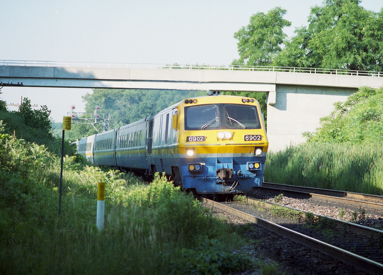 Hard to believe these BBD LRC-2 locomotives last saw service on the railroads back in 2001. Only 20 years (1981) from when they first appeared and now they are gone. And have already been gone over 20 years.   Speaks volumes, I'd guess, about their (lack of) reliability. I enjoyed seeing them, since they were replacing Tempo trains thru Bayview, and any of us out trackside in those days had seen enough of the Tempos.
VIA was the only outfit to order these LRCs; totaling 31 engines (6900-6930) and they also 100 coaches, many of which are still seen along the lines. Two locomotives, 6917 and 6921 survive; the rest have been scrapped.
This image is of which I believe #70 (lost my notes) judging by the sun angle, rolling eastward under the "Railfans Walk bridge" at the Botanical Gardens just east of Bayview Junction. Beautiful day and not a soul on the bridge.