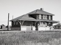 Among the maze of grain-gathering branchlines between Prince Albert and North Battleford was CN’s Robinhood sub., timetable westward from Speers Jct. through to Medstead then Glaslyn, and around the midpoint was Rabbit Lake, with its depot seen from the west end and in well-maintained condition on Saturday 1976-10-09.