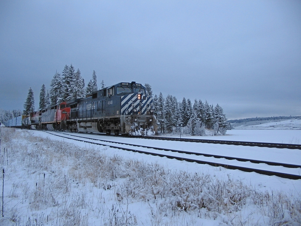 January 11, 2006, we were in the siding at Wright BC along the shore of Lac La Hache waiting for a southbound train. BCOL 4648 leading a trio of locos, and way back in the train was another 3 unit DPU set, unfortunately my image of the DPU's was way too blurry to post.. CN in their PSR wisdom was running some monster trains on BC Rail from Prince George south, generally 3 units on the headend and a trio of MU'd  DPU units mid-train. It was a gloomy afternoon for photos.