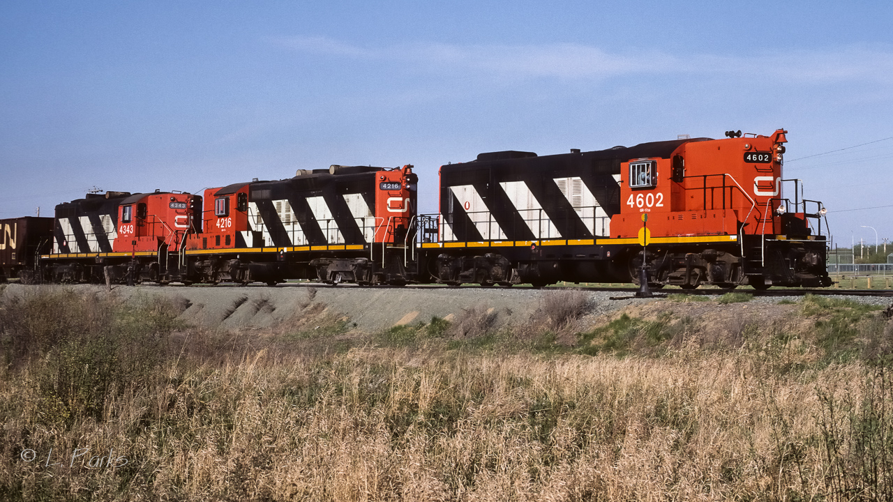 A short unit train of sulphur was passing the north switches to the siding and elevator tracks at Gibbons. For trains heading home, Gibbons was the last town you passed through. In a half hour or so, Edmonton will have become the dominant feature on the horizon. Now for something completely different, (for those that like numbers). Total the numbers on the lead unit, 4+6+0+2=12, do the same for the other 2. You end up with 12, 13 and 14. Seems these units were in their natural order. :-)