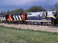 First thing in the morning finds a unit train of empties on the way north to exchange them for loaded hoppers. As far north as this train would go, the there and back time was not that long typically. Like this day, most unit trains would head out between 7:00 and 8:00 and return the next day anywhere from 16:00 to 20:00. Photo taken just north of Egremont with storm clouds already making an appearance in the west.