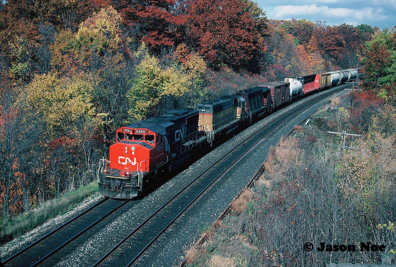 During a now sunny late fall afternoon, a CN westbound powered by SD40-2(W) 5362, a former Union Pacific SD40-2 (now CN) and a GP40-2L(W) is viewed approaching Bayview Jct. in Burlington, Ontario on the Oakville Subdivision.