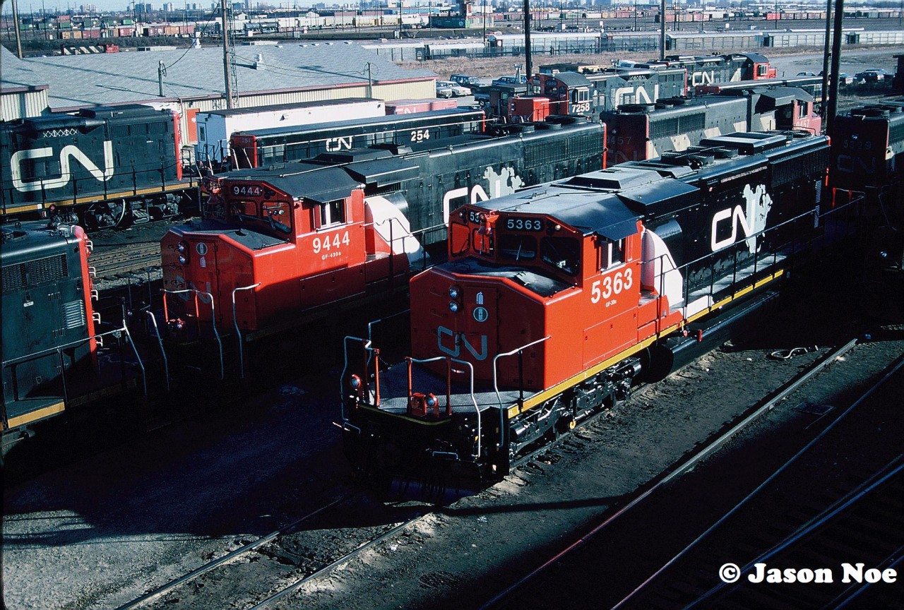 CN SD40-2(W) 5363 and GP40-2L(W) 9444 show off their somewhat still fresh CNNA colors as they wait to depart the MacMillan Yard diesel shop tracks amongst a sea of other motive power in Vaughan, Ontario.