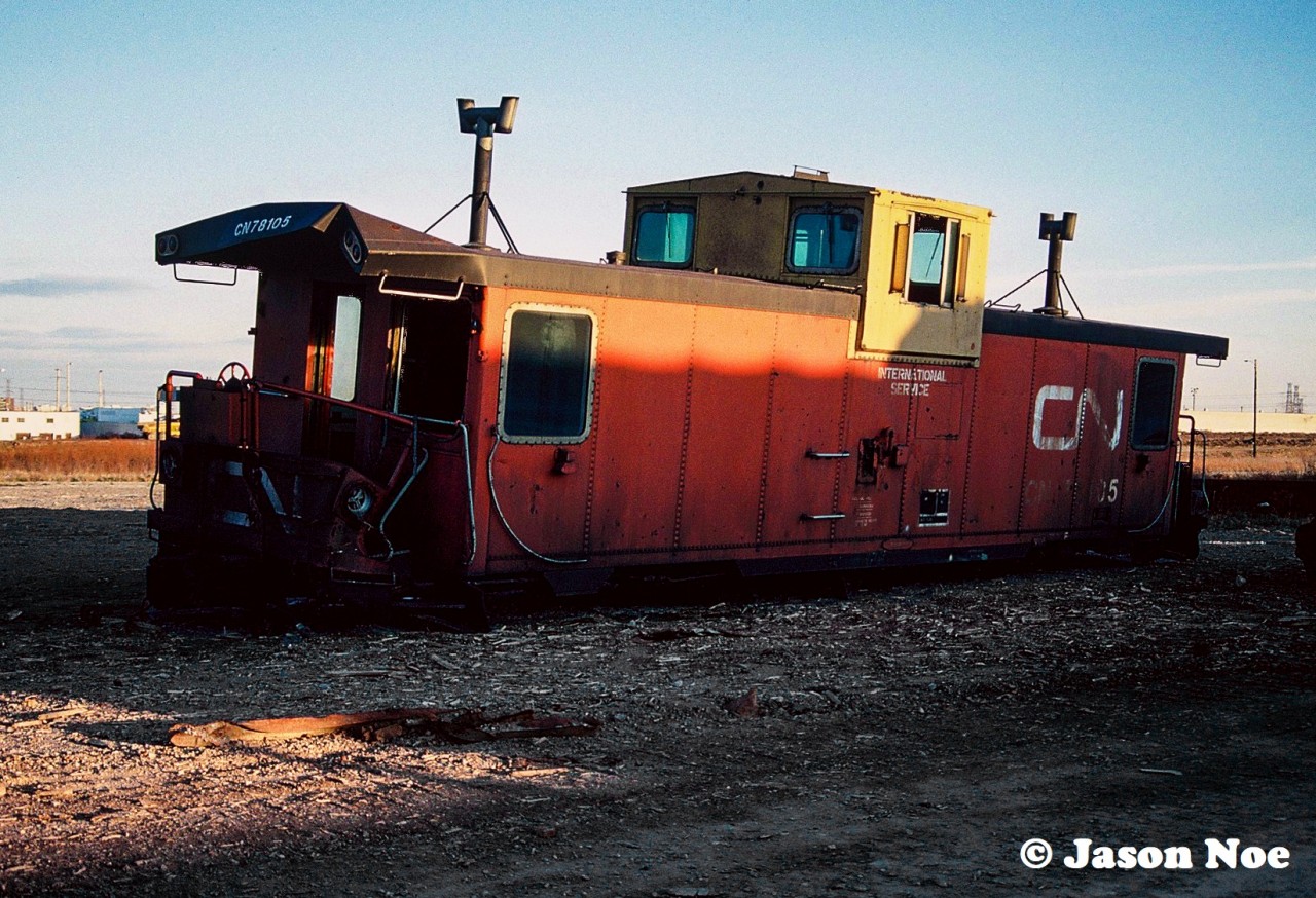 CN International caboose 78105 gets too see at least one more sunset as it awaits its eventual fate at CN’s S Yard in Vaughan, Ontario. Situated beside the Highway #7 overpass the stub-ended tracks were a portion of CN’s MacMillan Yard and used for the storage of older and retired cars, which eventually were scrapped on site.