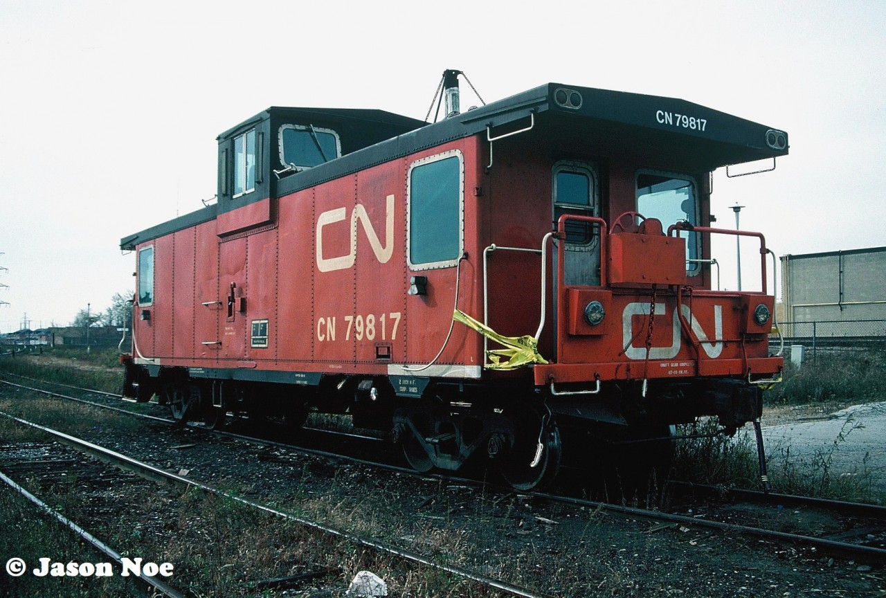 CN caboose 79817 shows obvious signs of damage as it sits at Burlington West, Ontario on the CN Oakville Subdivision. One wonders if it was ever repaired or was just taken to MacMillan Yard and eventually scrapped.