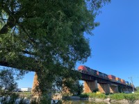 CN 2550 (GE C44-9W) and 5700 (EMD SD75I), both representing CN's late 1990's power investments, lead a handsome stack of intermodal containers across the storied Port Hope viaduct. 

Always a treat when you catch two locomotives still sporting pre-website logos!