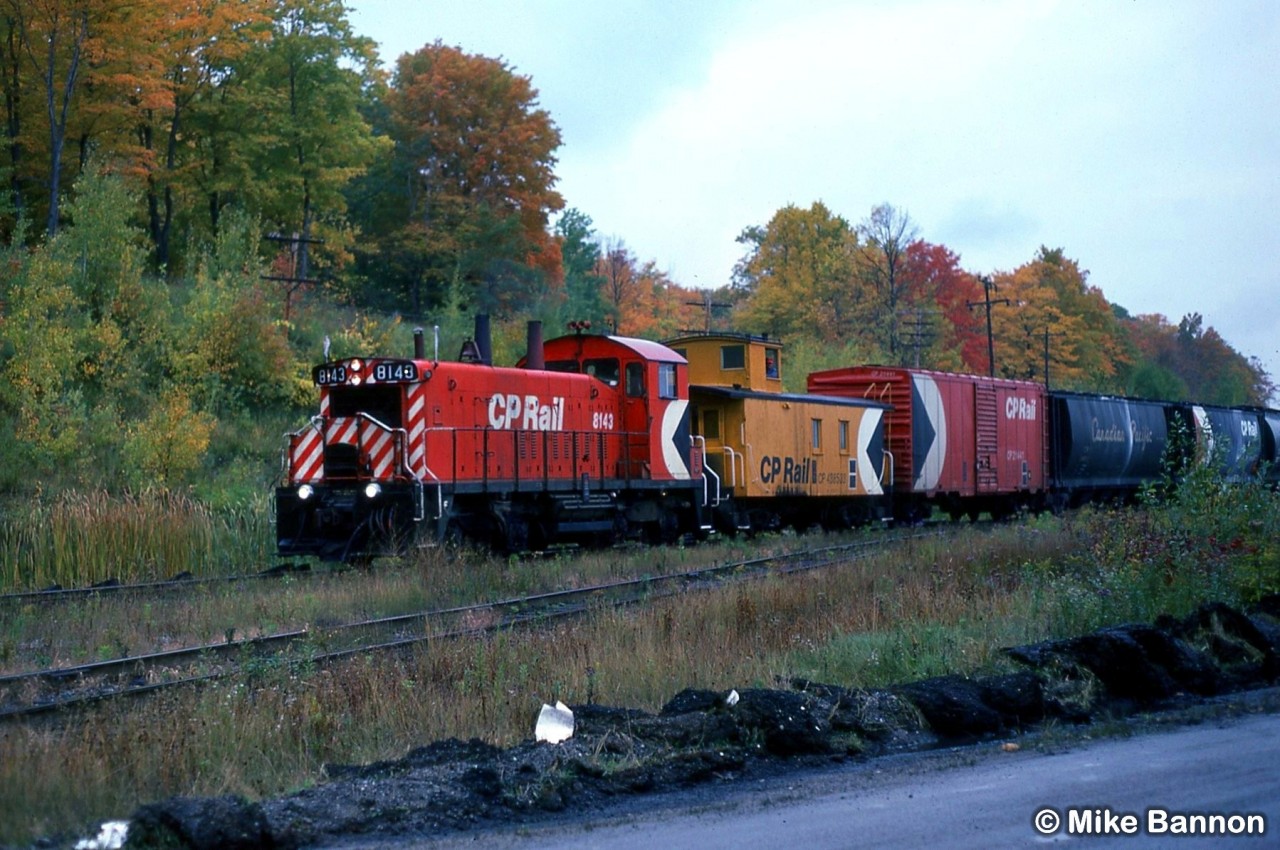 CP SW1200RS 8143 and caboose returning to Port McNicoll after dropping grain boxes at Tiffin Elevator on Midland Harbour