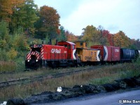 CP SW1200RS 8143 and caboose returning to Port McNicoll after dropping grain boxes at Tiffin Elevator on Midland Harbour