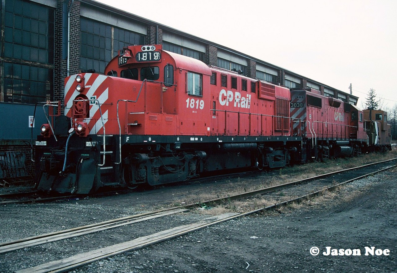 CP RS-18u 1819 and GP38-2 3038 wait between assignments at CP’s Aberdeen Yard in Hamilton, Ontario with a caboose. Not many CP GP38-2’s were repainted in the action red paint minus the multi-mark prior to the duel flags paint scheme being introduced in 1993.