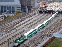 GO Transit F59PH 520 slowly pushes its train westward into Track 6 of the train shed at Toronto's Union Station downtown, with another F59PH poking its nose from underneath on Track 7 as PM rush hour is in full swing.
<br><br>
Quite a few things have changed since this 2006 view of the USRC and surrounding area near Scott Street interlocking tower, including a new condo being built on the small parcel of land and nearby parking lot at the bottom right (blocking this condo's view). The Air Canada Centre (note logos and lettering) is now Scotiabank Arena, and a lot more condos and office towers populate the downtown skyline. That parking lot on the left is now home to an office tower with GO's new bus terminal in it. The shuttered ex-CPR John St. Roundhouse in the background is now home to a railway museum, among other things. And GO 520, retired in 2009, went on to work a short stint leased to VIA, then SoCal on Metrolink, and finally ended up at a start-up passenger operation in Mexico!