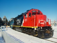 CN 4951's paint pops in the sun and snow as it leads CN 500 out of the Port of Montreal.