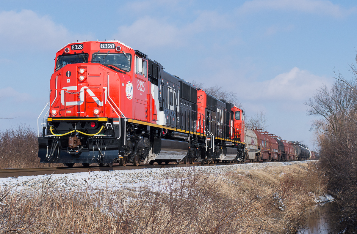 CN L502 is on the last leg of their trip from Sarnia to Garnet as they approach the grade crossing at Sandusk Road.  Leading the train is brand new SD75iACC's 8328 and 8317.