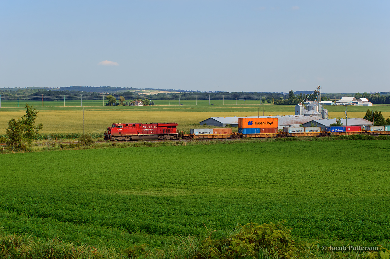 Intermodal traffic bound for the west coast is stretched out across the New Tecumseth countryside as CPKC 113 approaches the south end of Baxter.