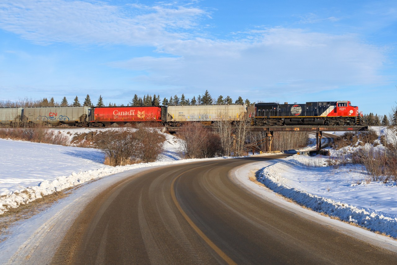 Retro Logo CN 3331 climbs the grade out of Sherwood Park with a grain train for Humboldt.