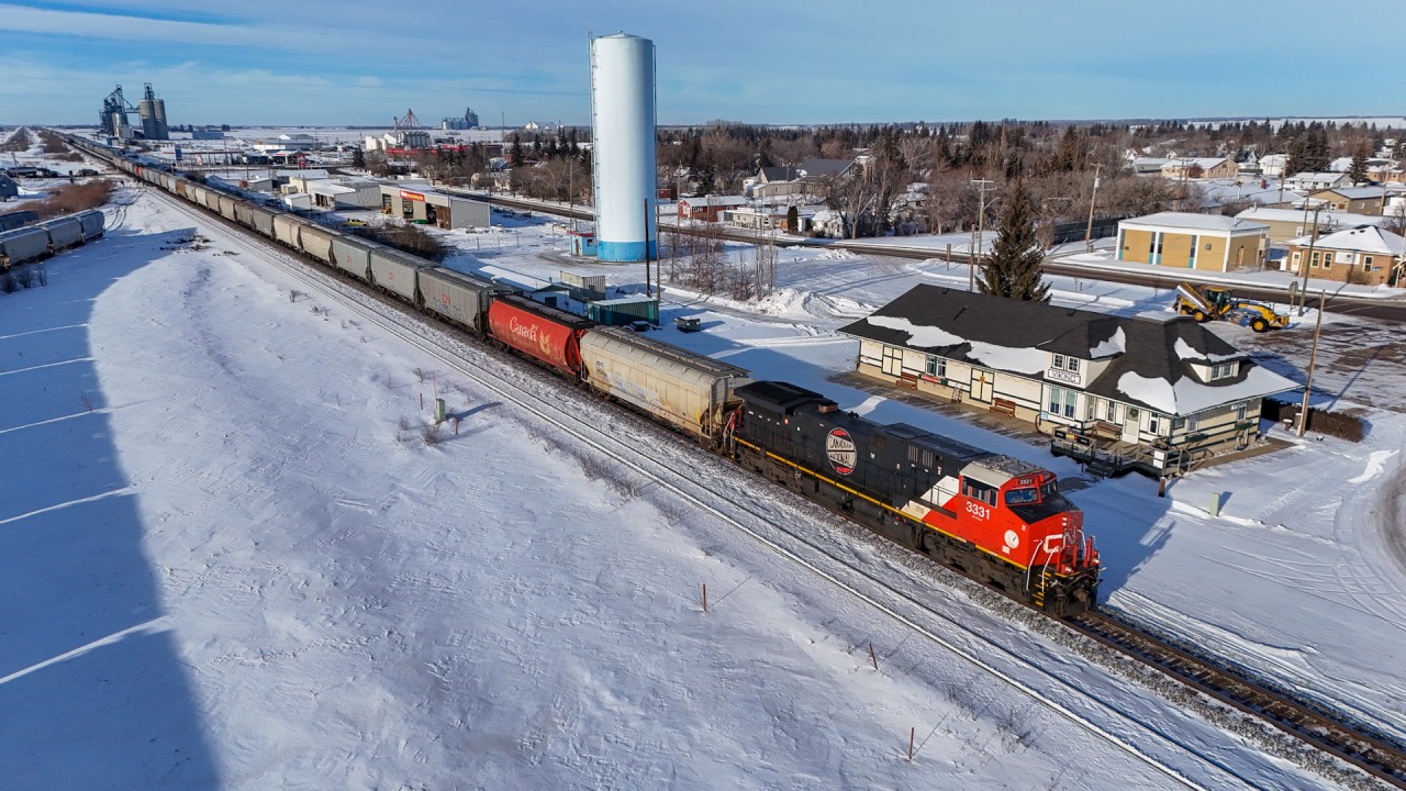 G 80852 07 rolls past the beautifully restored station at Viking, Alberta with CN 3331 leading.