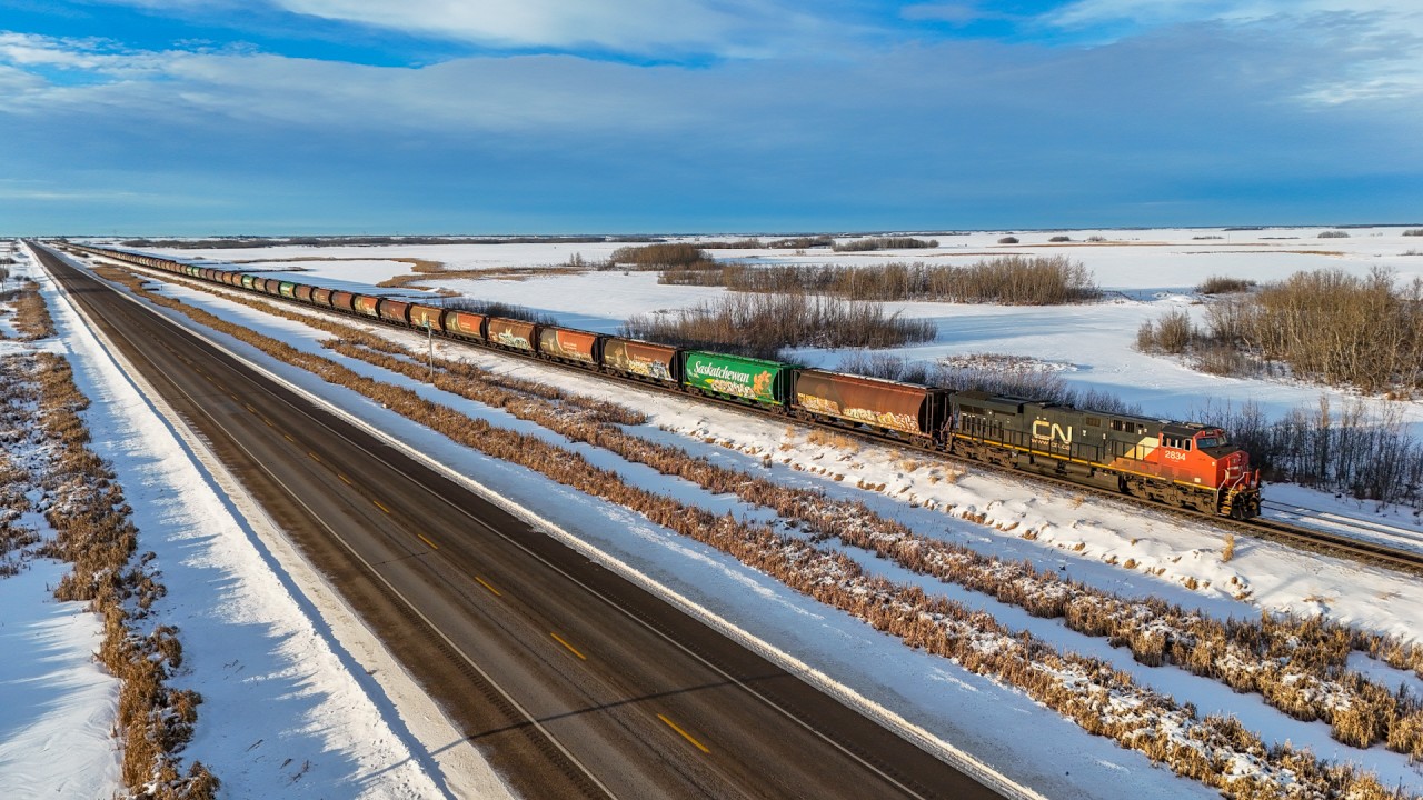 Looking like a classic prairie grain train of yesteryear (minus the GEVo!), G 84252 07 holds the main at Bruce, Alberta with 100 Saskatchewan cylindrical hoppers on the headend.  All cars wear MGLX (Mobil Grain) reporting marks and many of the various Saskatchewan schemes to adorn these quintessentially Canadian grain cars.  For a video of this train, check the comment section below.