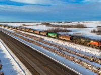 Looking like a classic prairie grain train of yesteryear (minus the GEVo!), G 84252 07 holds the main at Bruce, Alberta with 100 Saskatchewan cylindrical hoppers on the headend.  All cars wear MGLX (Mobil Grain) reporting marks and many of the various Saskatchewan schemes to adorn these quintessentially Canadian grain cars.  For a video of this train, check the comment section below. 