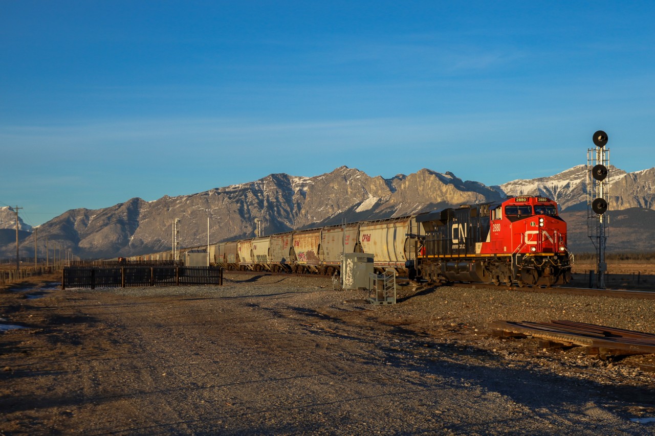 At a classic Canadian Pacific location, CN 2880 east blasts through Ozada with an empty grain train just moments after sunrise.