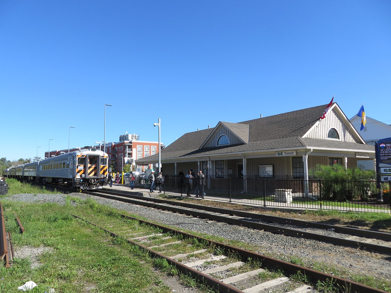 In better days, the York-Durham passenger train lays over adjacent to the GO Transit station in Stouffville before heading back to Uxbridge.