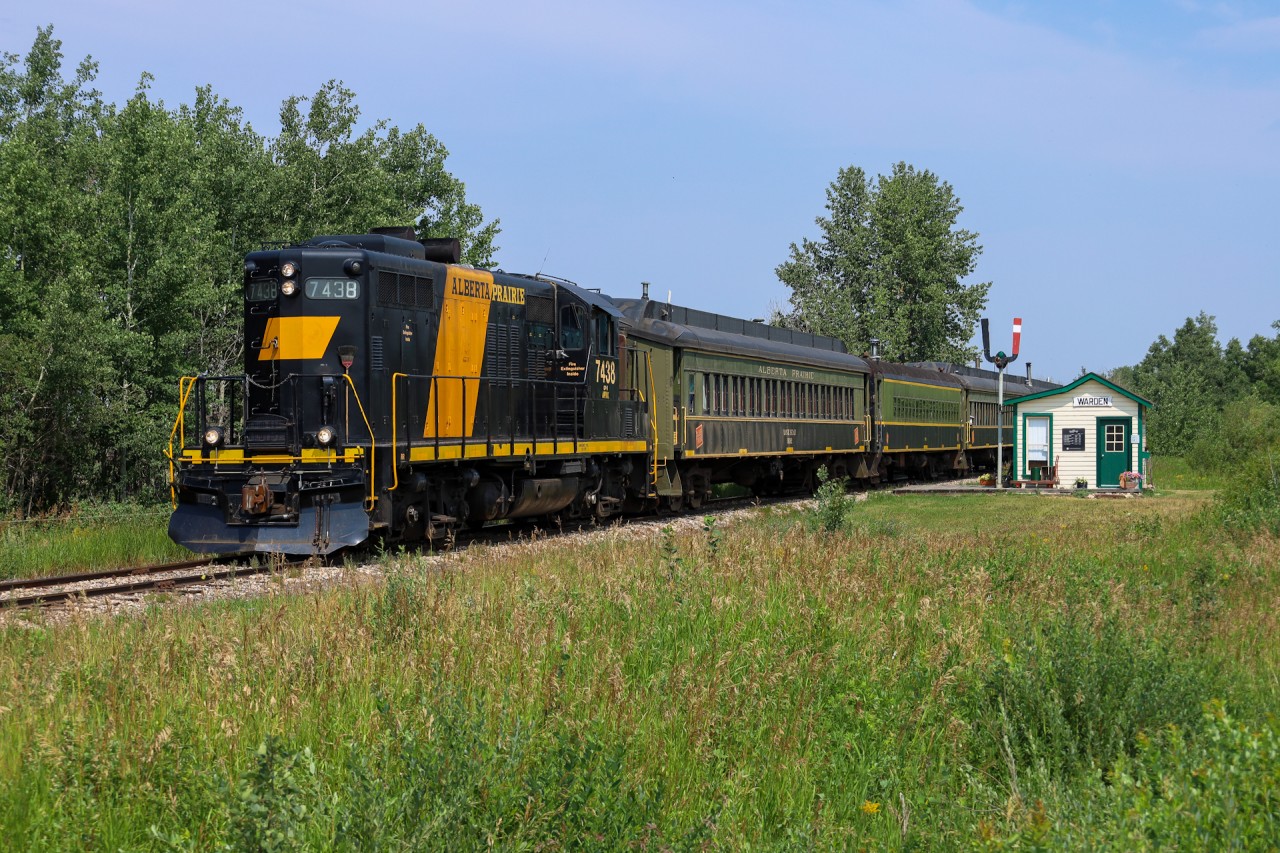 Alberta Prairie train 26 rolls into Warden, past a refurbished Canadian Northern Railway station.  Check out the comment section for some links of this unit in various schemes.