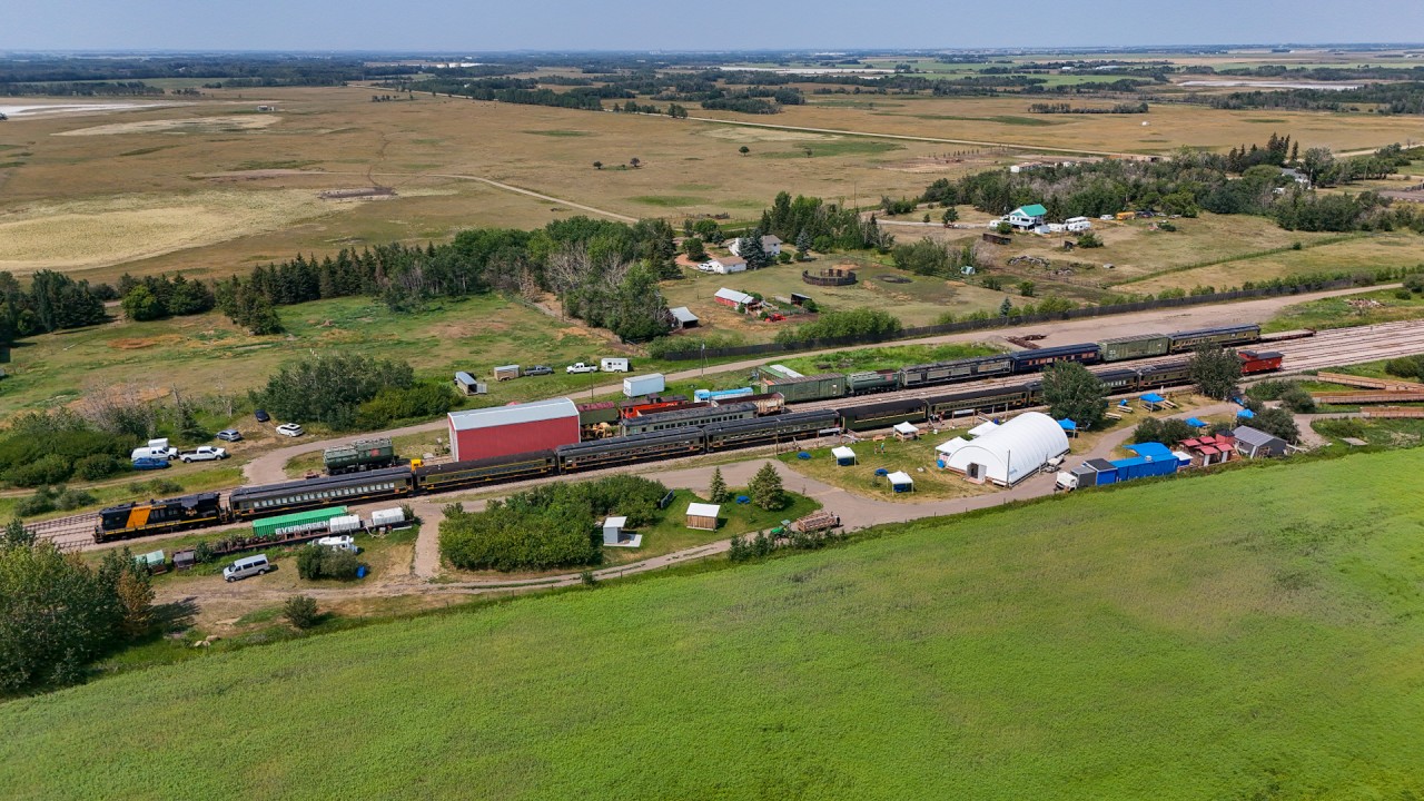 Alberta Prairie Railway train 26 sits at the “Country Hideaway” at Warden.  Tucked away in the shop building is the CN 6060.