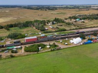 Alberta Prairie Railway train 26 sits at the “Country Hideaway” at Warden.  Tucked away in the shop building is the CN 6060. 