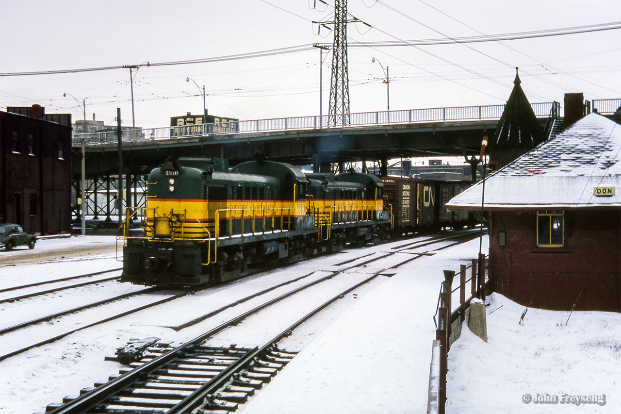 Train 452 from North Bay to Toronto curves past Don station as it enters the Toronto Terminals Railway trackage behind a pair of ONR RS3s.  Scan and editing by Jacob Patterson.