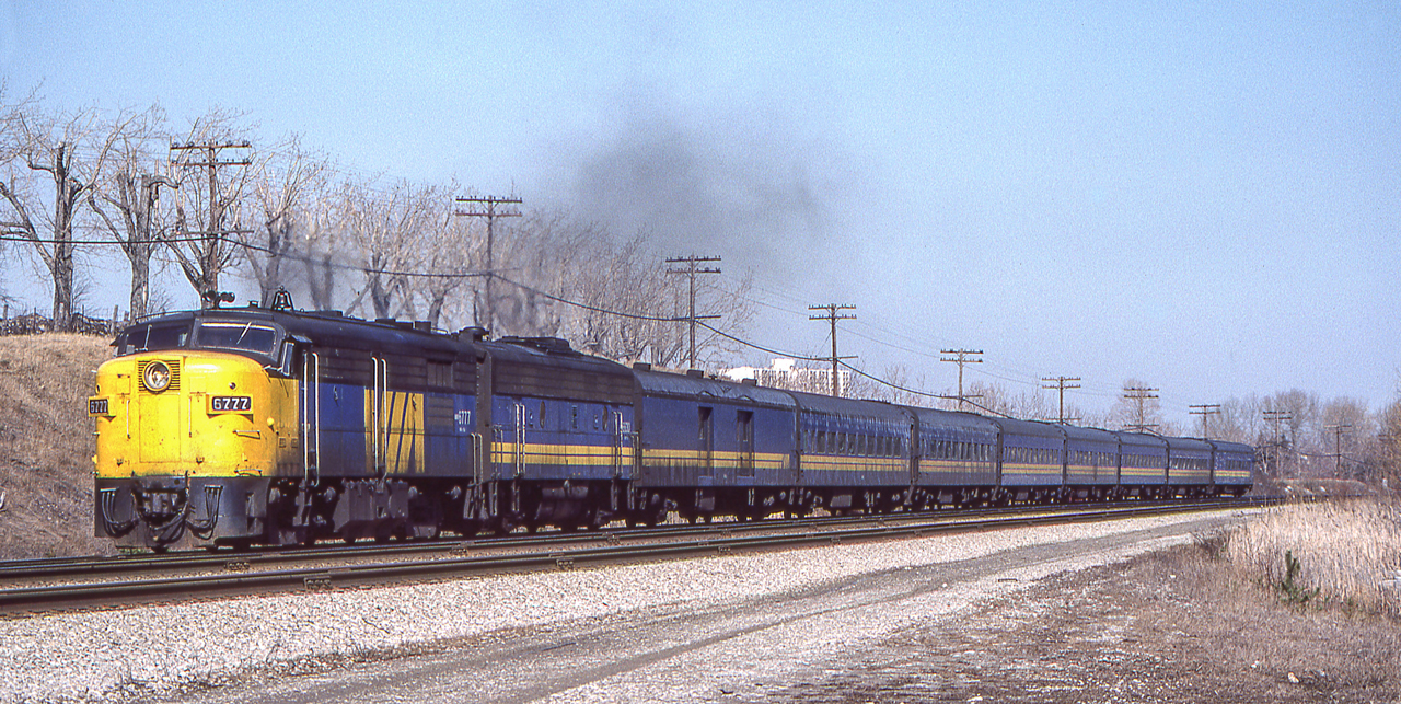 VIA 6777 and her train are in Scarborough, Ontario on March 23, 1982.