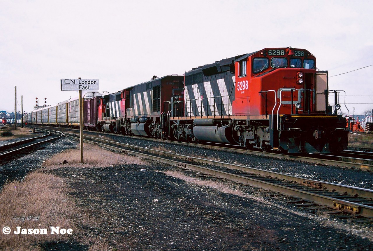 CN train 380 is viewed paused for its crew change across from the CN office building at London East on the Dundas Subdivision. Powering the Windsor-Toronto train is SD40-2(W) 5298, HR616 2108 and GP40-2(W) 9668. CN 2108 was retired on February 13, 1998 and was part of a group of retired HR616’s later sold to National Railway Equipment during June 1998.