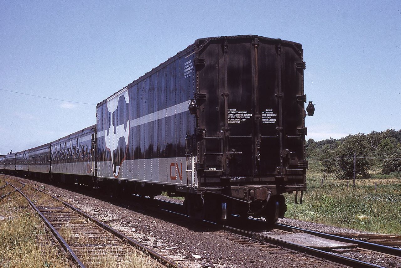 CN 9500 wears the markers for Canadian National Train #3, the Super Continental, at Maple, Ontario on Saturday July 3, 1974.