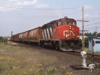 CN 9610 leads a "one lung wonder" south over the now removed switch to the Suez gravel pit.