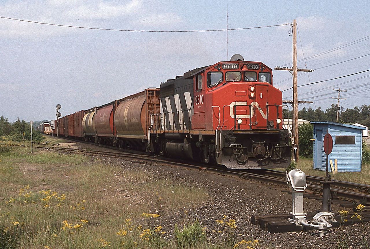 CN 9610 leads a "one lung wonder" south over the now removed switch to the Suez gravel pit.